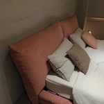 Soft Pink Upholstered Bed with Oversized Cushion Headboard & Rounded Base